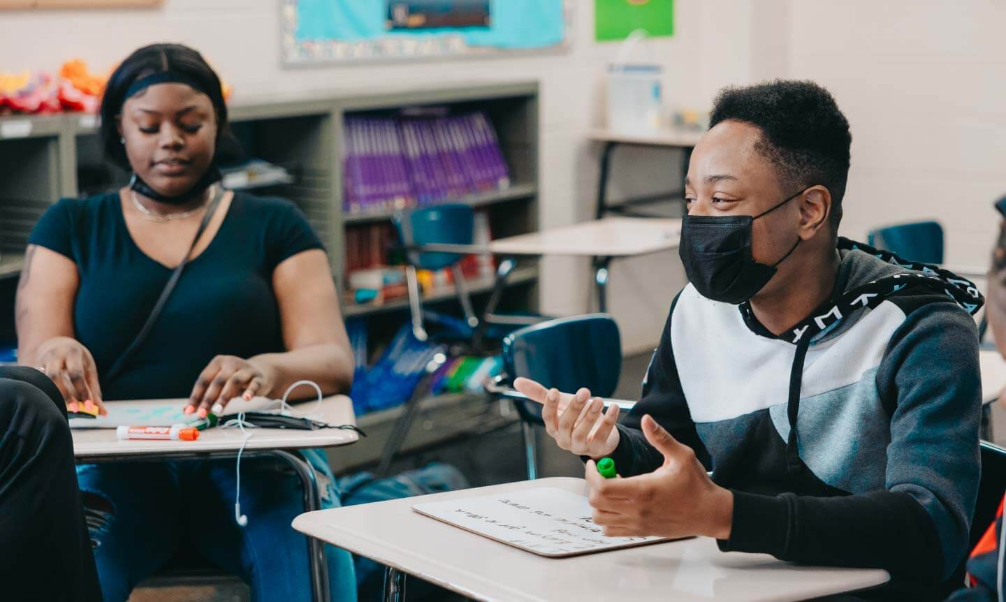 Uplift_student-at-desk-talking